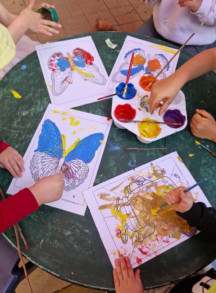 Children focused on artwork during family day care activities