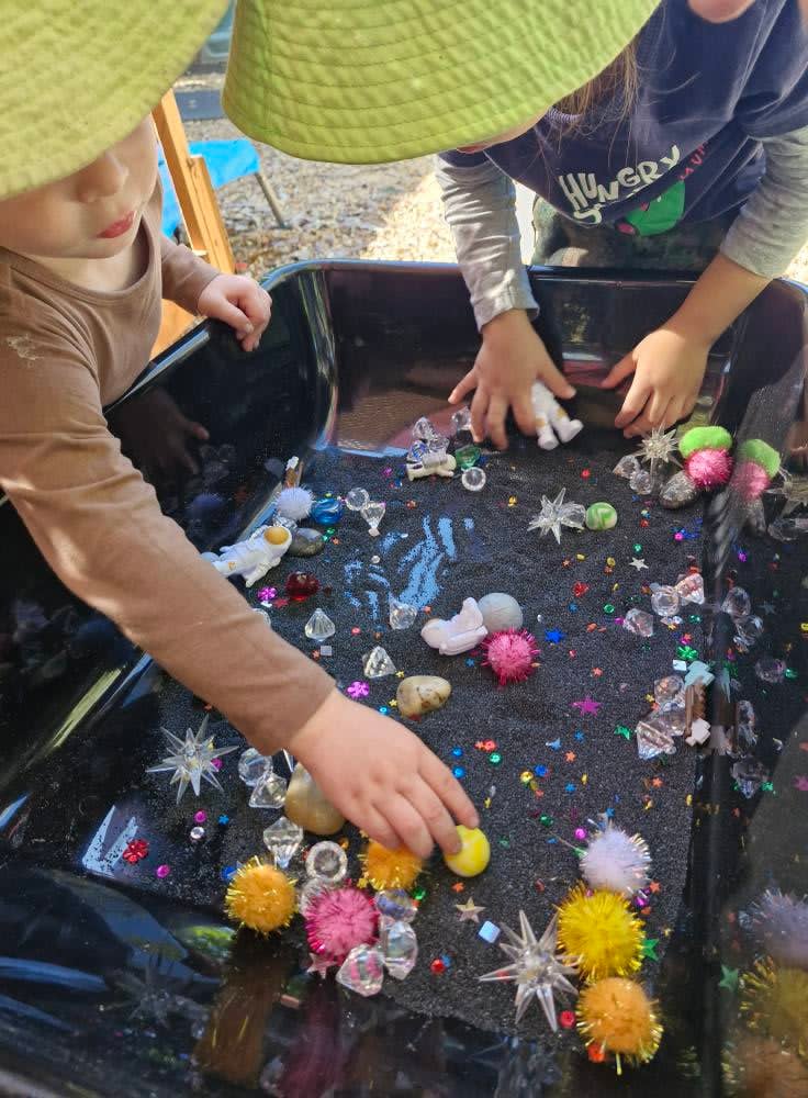 Cosmic-themed sensory bins for children at Mayra's Little Stars